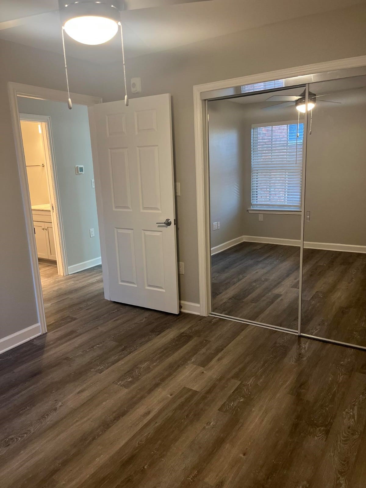 3737 Timberglen Road, Unit 2110 Dallas, TX 75287 - Photo 12 of 19 an empty room with wooden floor and windows
