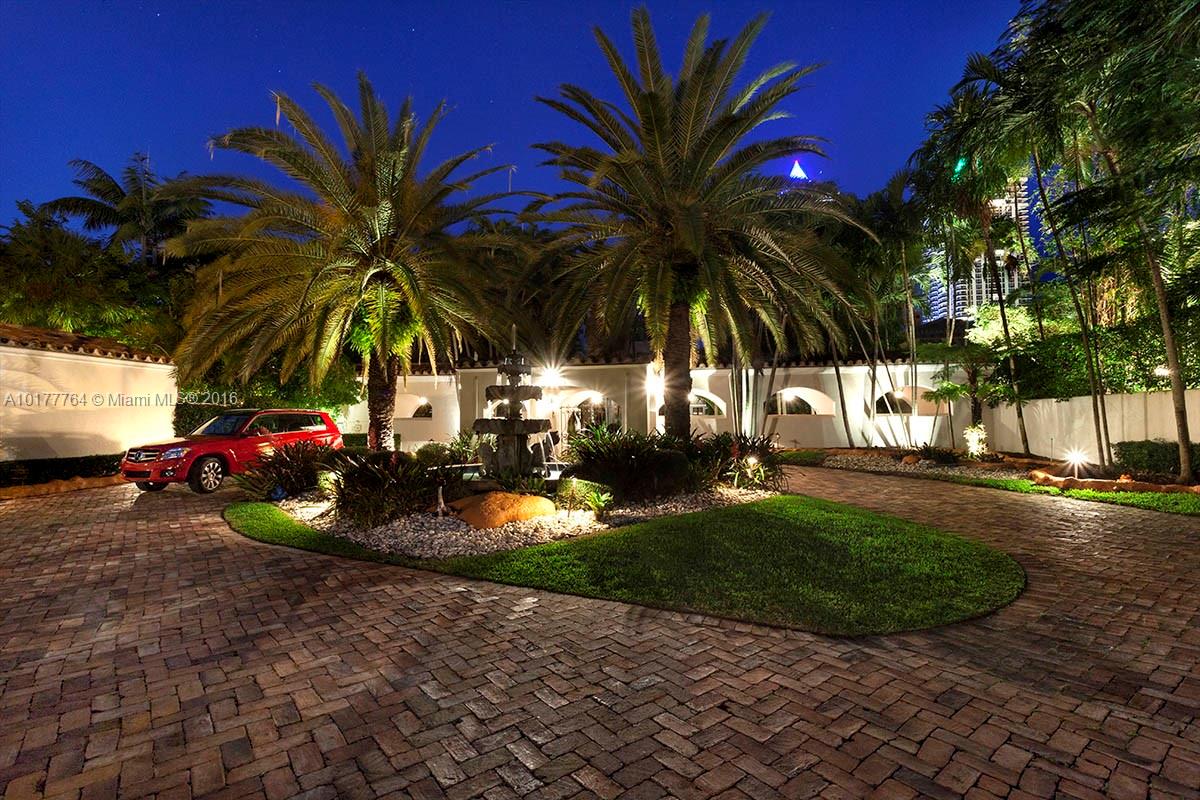4855 Pine Tree Drive Miami Beach, FL 33140 - Photo 15 of 26 a view of a backyard with a garden