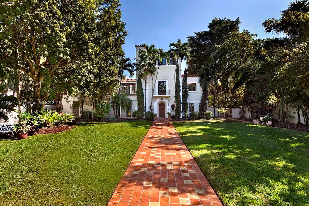 4855 Pine Tree Drive Miami Beach, FL 33140 - Photo 17 of 26 a front view of a house with garden