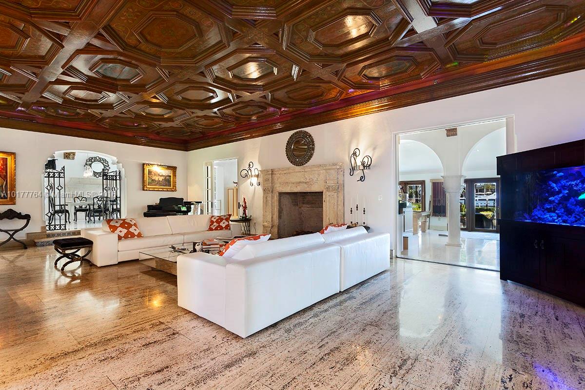 4855 Pine Tree Drive Miami Beach, FL 33140 - Photo 18 of 26 a living room with furniture and a fireplace