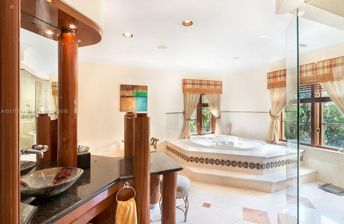 4855 Pine Tree Drive Miami Beach, FL 33140 - Photo 19 of 26 a kitchen with a table and chairs