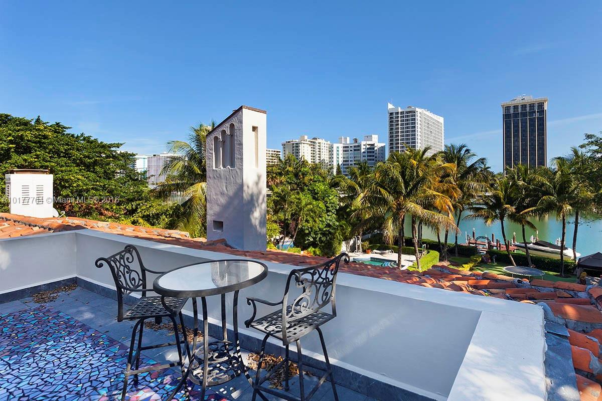 4855 Pine Tree Drive Miami Beach, FL 33140 - Photo 21 of 26 a view of a chairs and table in patio
