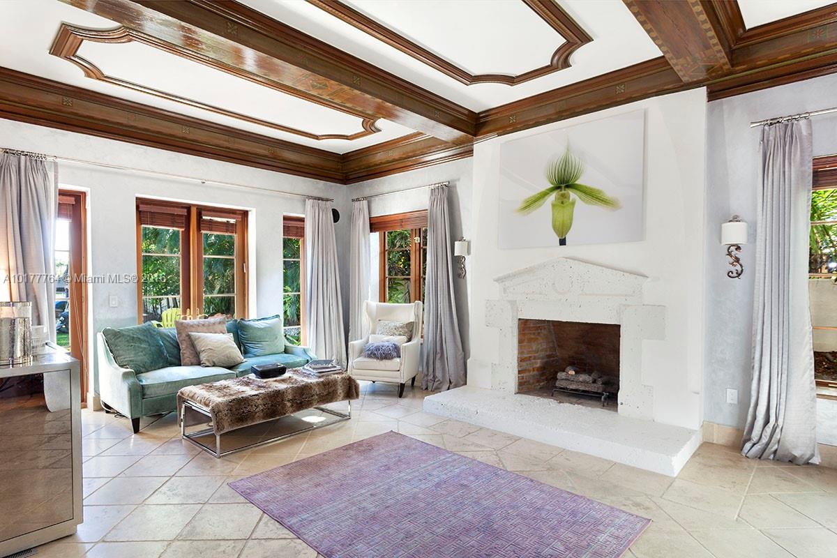 4855 Pine Tree Drive Miami Beach, FL 33140 - Photo 24 of 26 a living room with furniture and a fireplace