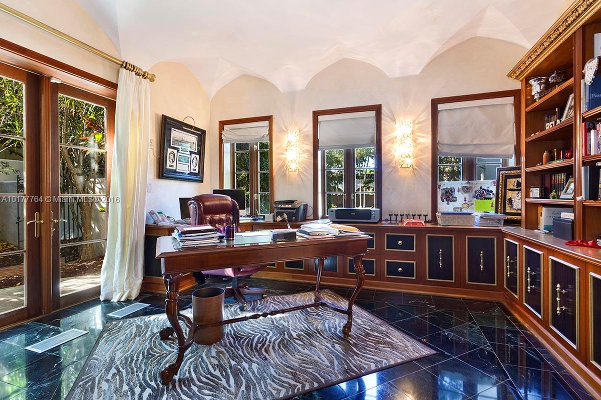 4855 Pine Tree Drive Miami Beach, FL 33140 - Photo 25 of 26 a living room with furniture and a bookshelf