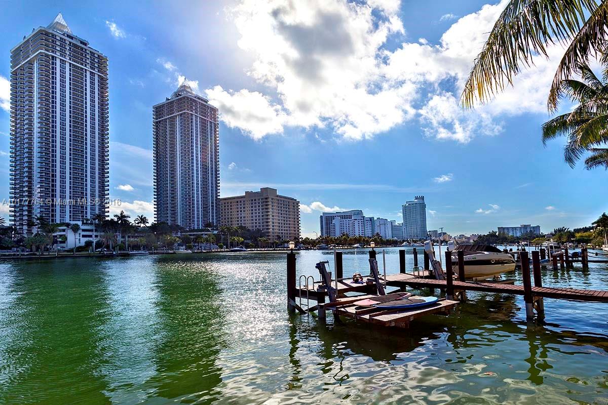4855 Pine Tree Drive Miami Beach, FL 33140 - Photo 4 of 26 a table and chairs sitting in the terrace