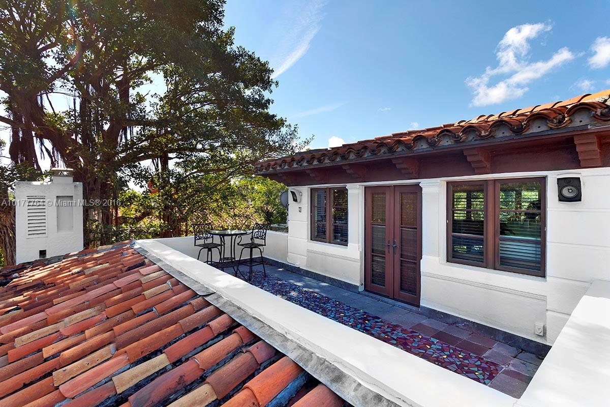 4855 Pine Tree Drive Miami Beach, FL 33140 - Photo 6 of 26 a front view of a house with garden