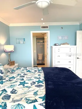 a bedroom with a bed and a mirror