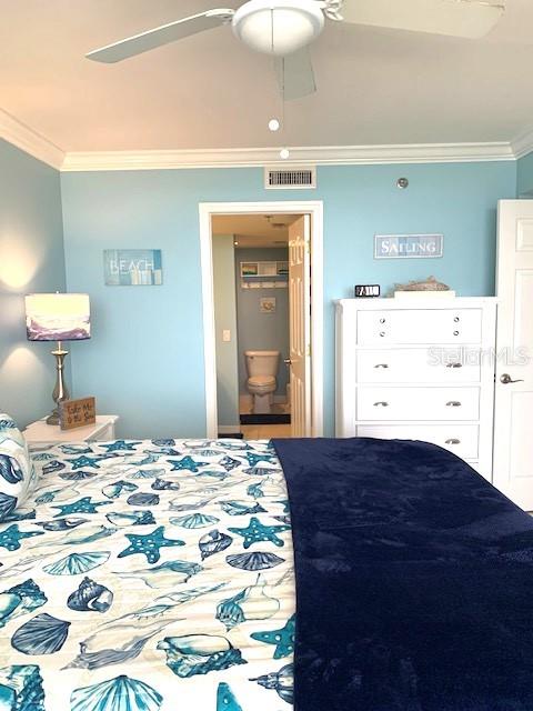 6009 Sea Ranch Drive, Unit 303 Hudson, FL 34667 - Photo 13 of 48 a bedroom with a bed and a mirror