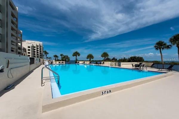 a view of swimming pool with outdoor seating