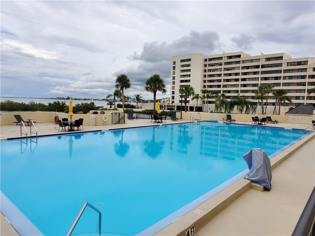 6009 Sea Ranch Drive, Unit 303 Hudson, FL 34667 - Photo 28 of 48 a view of a swimming pool with outdoor seating