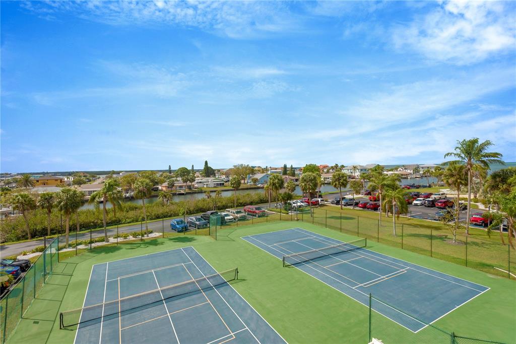 6009 Sea Ranch Drive, Unit 303 Hudson, FL 34667 - Photo 37 of 48 a view of an outdoor space and tennis court