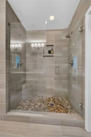 a living room with furniture tv and a floor to ceiling window