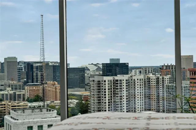 a view of a city with tall buildings and a big yard