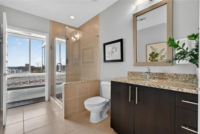 a view of a patio with a table and chairs and potted plants