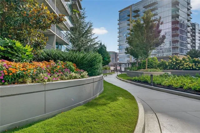 a patio with a table and chairs and potted plants