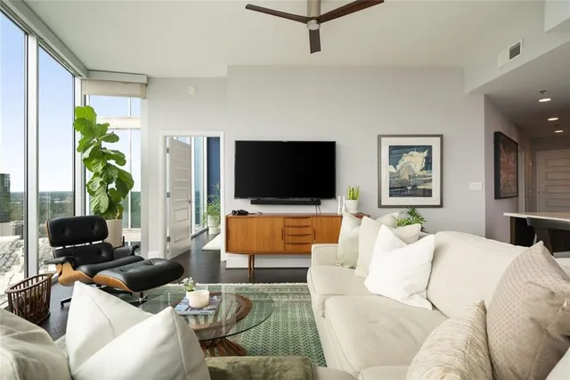 a living room with furniture and kitchen view