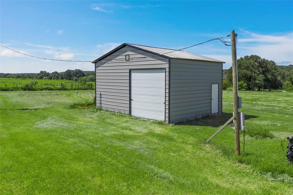 101 Private Road Aquilla, TX 76622 - Photo 12 of 19 a front view of a house with garden