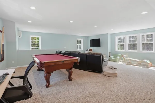 a room with furniture a flat screen tv and a window