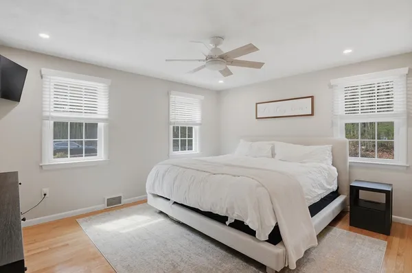a bed sitting in a bedroom next to a window