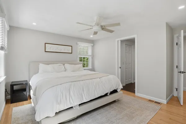 a bedroom with a bed and large mirror