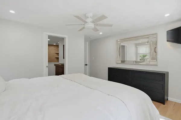 a bedroom with a bed and a chandelier