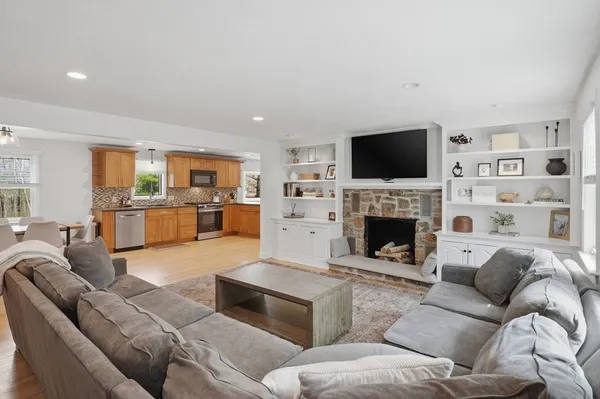 a living room with furniture a fireplace and a flat screen tv