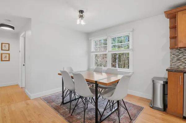 a dining room with furniture and window