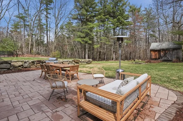 a view of a patio with table and chairs and couches