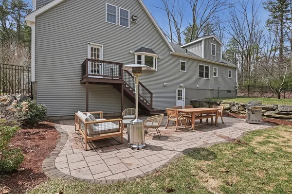 a view of a house with backyard and sitting area