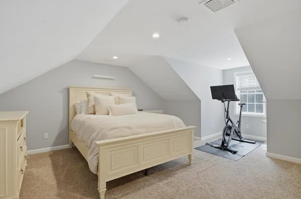 a bedroom with a bed and gym equipment