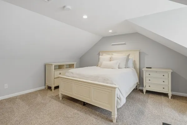 a bed room with a bed and a night stand