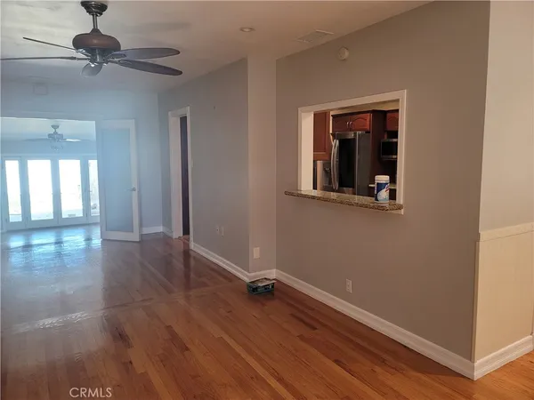 a view of empty room with wooden floor