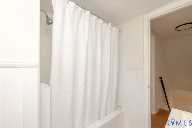 a view of an empty room with wooden floor