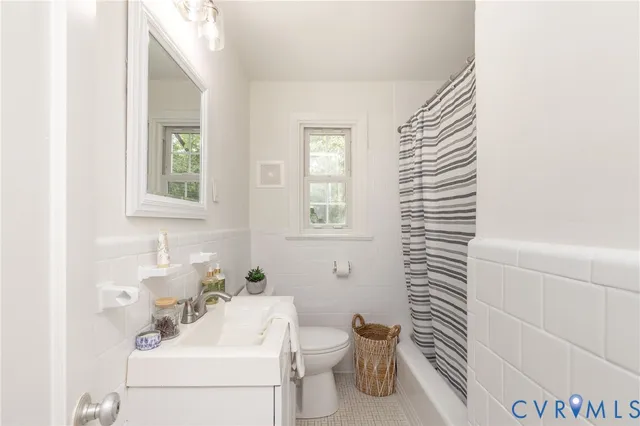 a view of a house with a yard and large trees