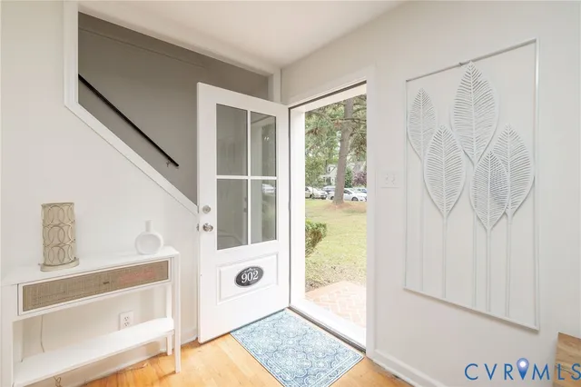 a dining room with furniture a chandelier and wooden floor