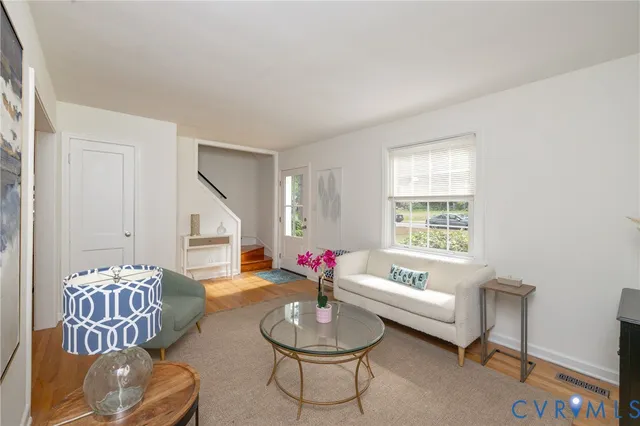 a kitchen with stainless steel appliances granite countertop a sink a stove a microwave oven and a window