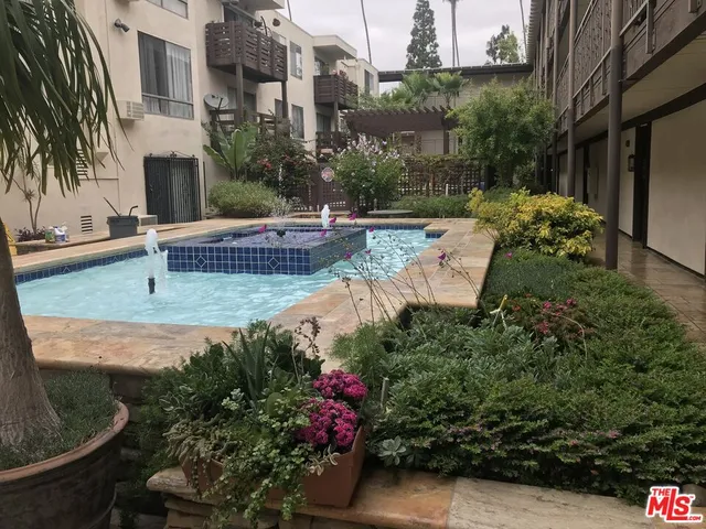 an outdoor view of garden with swimming pool