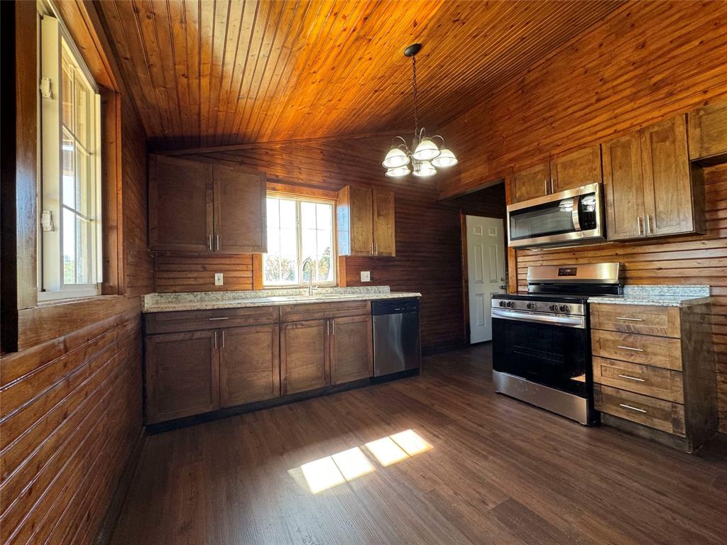 184 County Road Pattonville, TX 75468 - Photo 6 of 20 a large kitchen with a large counter top space appliances and cabinets