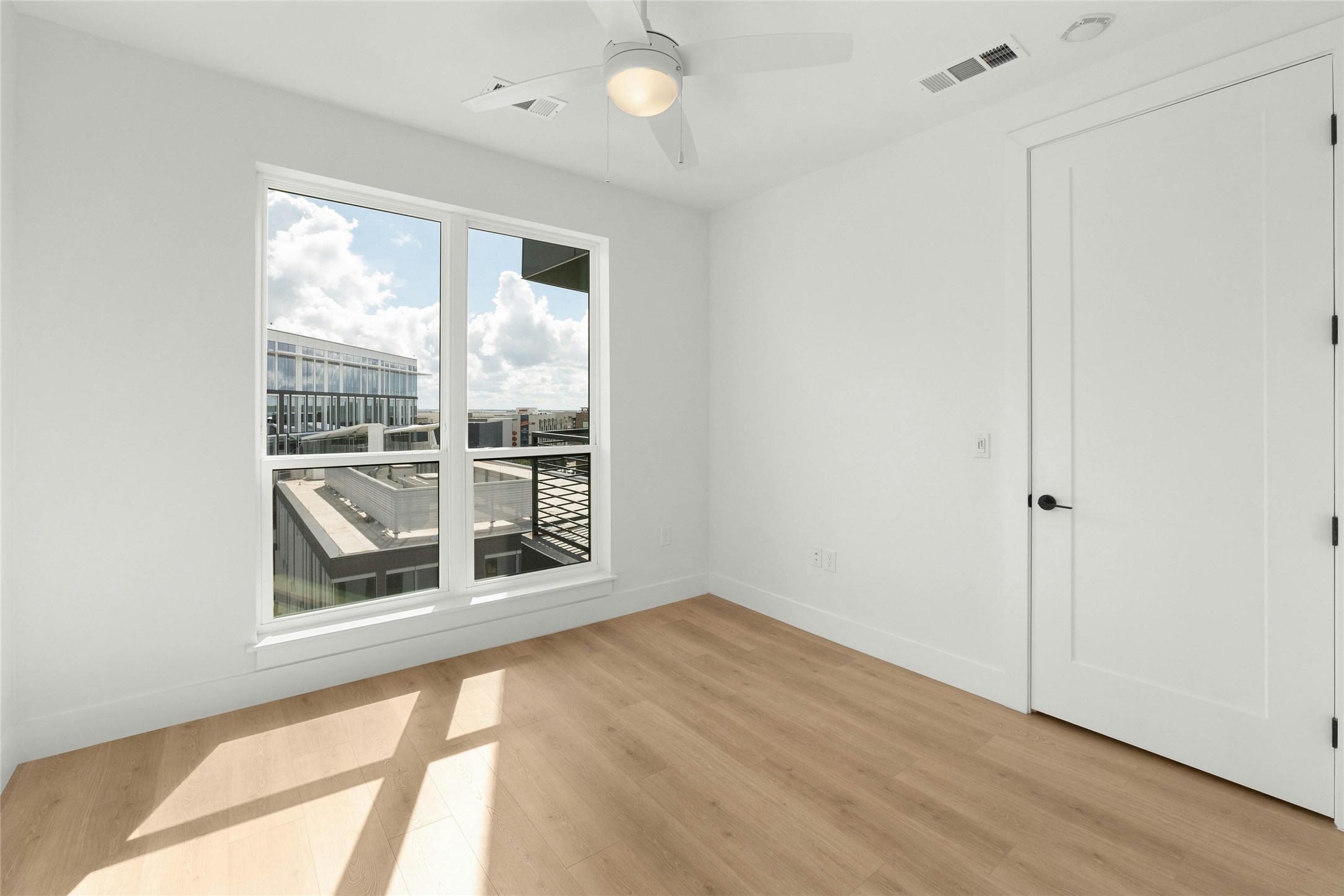 1701 Simond Avenue, Unit 644 Austin, TX 78723 - Photo 15 of 40 a view of an empty room with a window and wooden floor