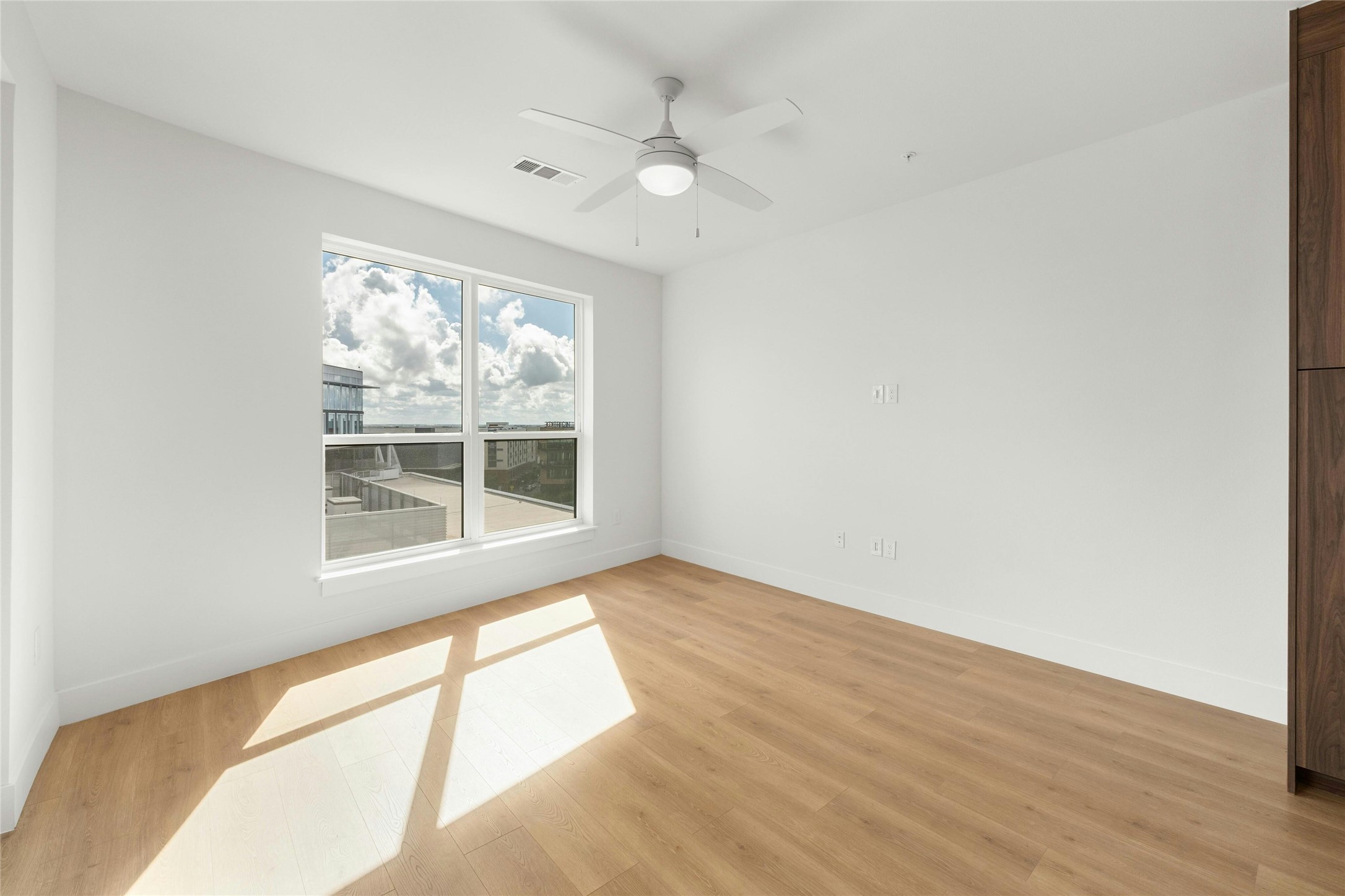 1701 Simond Avenue, Unit 644 Austin, TX 78723 - Photo 2 of 40 a view of an empty room with wooden floor and a window