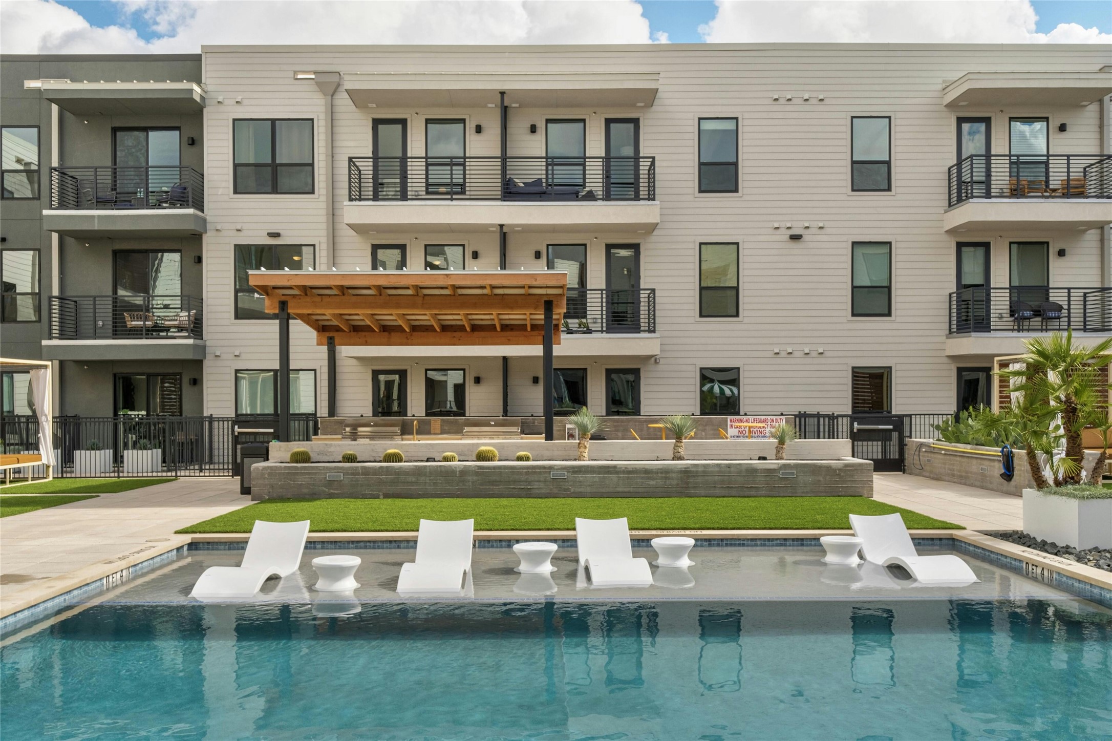 1701 Simond Avenue, Unit 644 Austin, TX 78723 - Photo 26 of 40 a white building with glass windows and a table