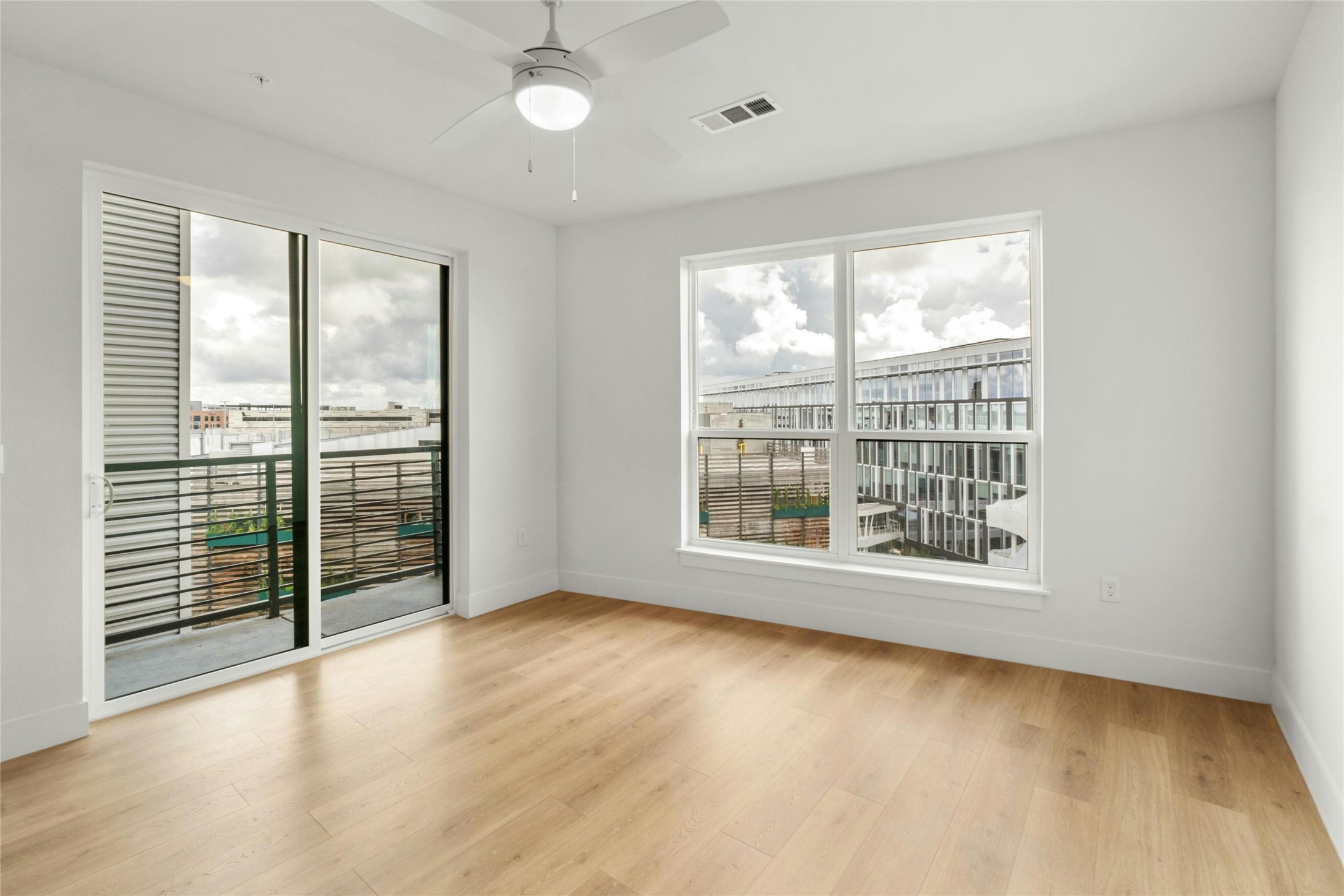 1701 Simond Avenue, Unit 644 Austin, TX 78723 - Photo 4 of 40 an empty room with wooden floor and windows