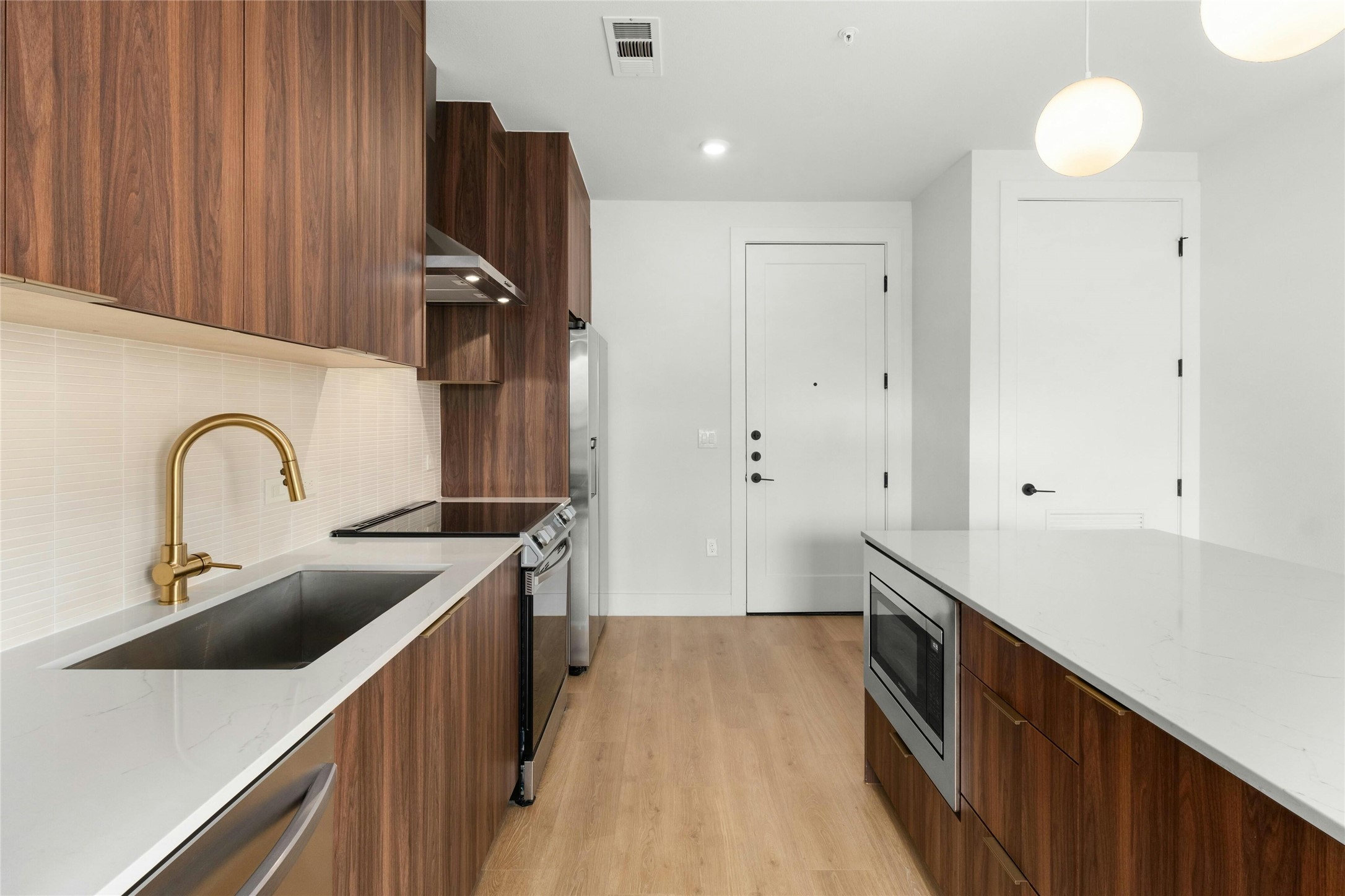 1701 Simond Avenue, Unit 644 Austin, TX 78723 - Photo 10 of 40 a kitchen with stainless steel appliances a sink cabinets and wooden floor