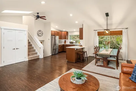 a living room with furniture and a wooden floor