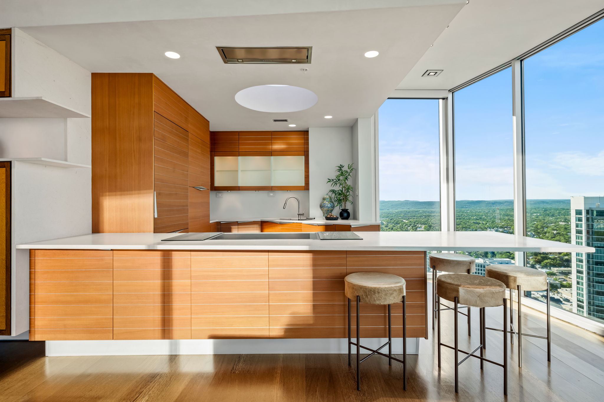 360 Nueces Street, Unit 4211 Austin, TX 78701 - Photo 12 of 40 a view of a kitchen with kitchen island a large window a sink and a counter top space