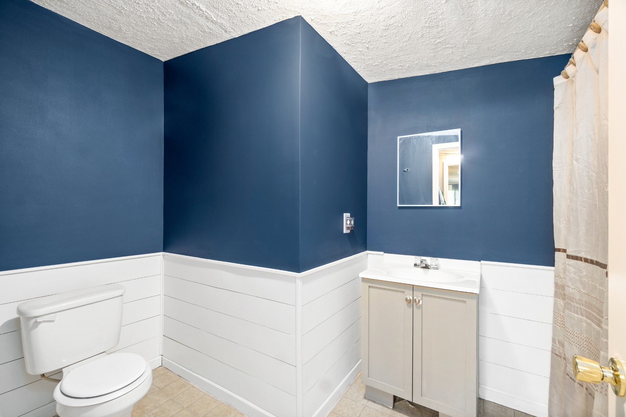 5775 Bryant Hollow Road Cunningham, TN 37052 - Photo 22 of 26 a bathroom with a sink a toilet and mirror