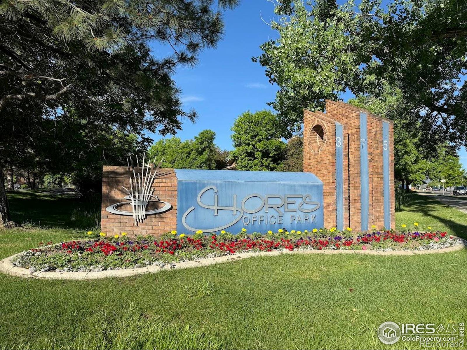 375 East Horsetooth Road Fort Collins, CO 80525 - Photo 3 of 4 a wooden fence with some potted plants and large trees