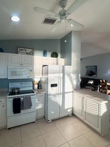 a kitchen with stainless steel appliances and white cabinets