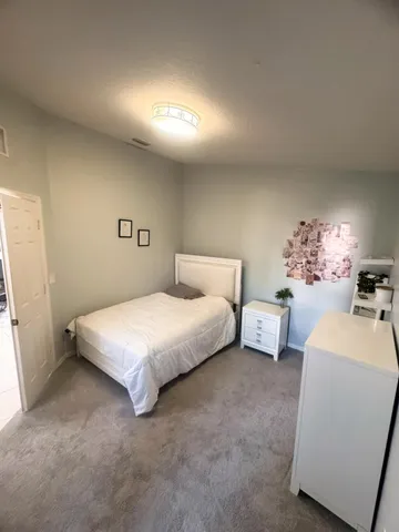 a bedroom with a bed and a couch