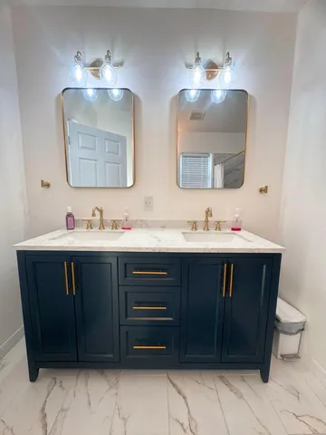 a bathroom with a sink vanity and a mirror